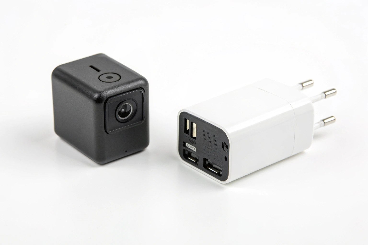 An image displaying two types of hidden cameras side-by-side: one is a small standalone cube with a battery, and the other is built into a standard USB wall charger.