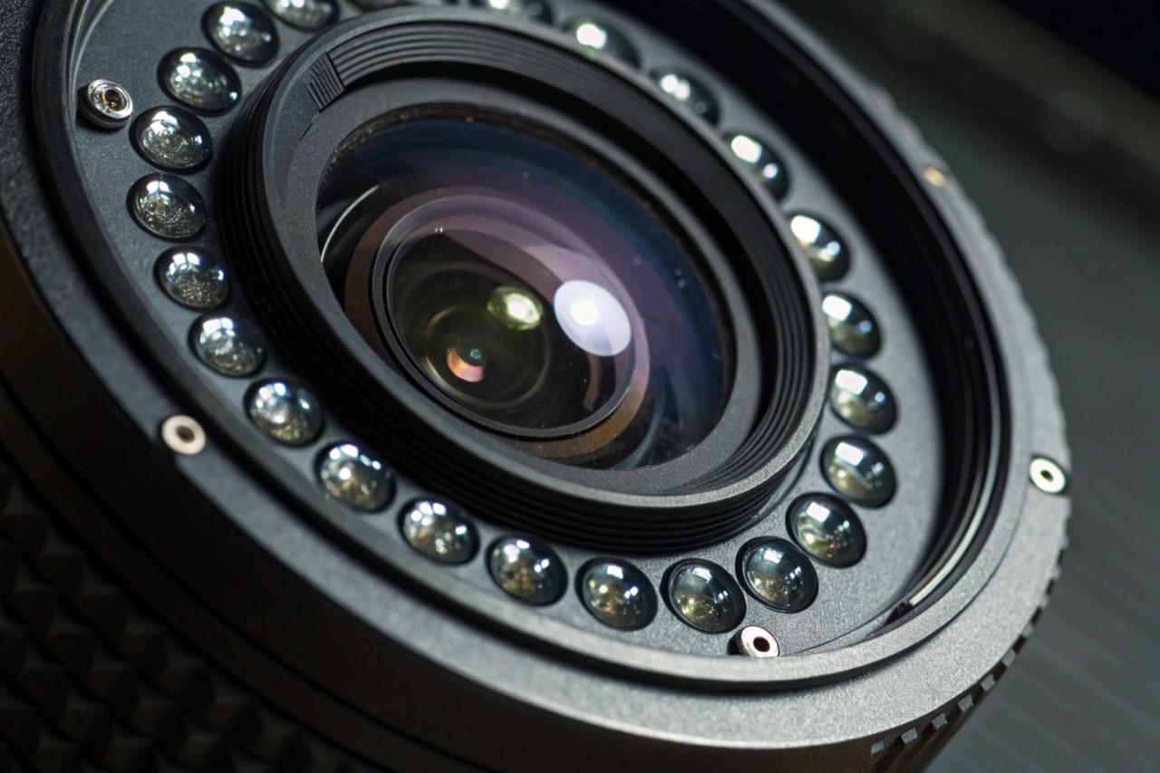 High-tech camera lens assembly showing infrared night vision sensors around the glass objective